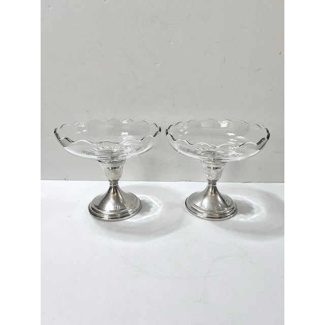 Pair of clear glass compotes with scalloped rims and weighted sterling silver bases. The glass bowls unscrew, converting...