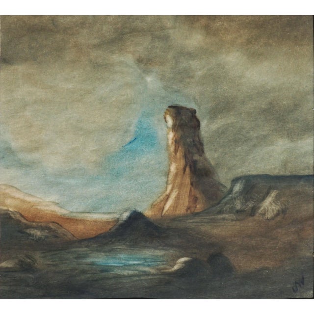 Early 20th-century watercolor landscape of a water hole beside a monolith under a stormy sky, oasis-like in the arid...