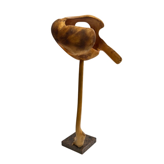 A striking vintage abstract sculpture hand-carved from what appears to be olive wood, mounted on a substantial natural...
