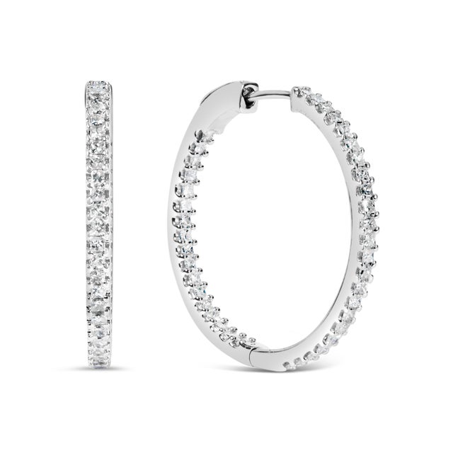 Discover timeless elegance with these exquisite 14K white gold hoop earrings, where luxury and brilliance interlace to...