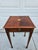 This Federal style inlay square mahogany side table has a pull-out drink tray and cute tapered legs terminating in spade...