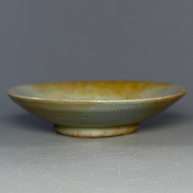 This antique Chinese shallow plate features elegant crackle glaze with natural aged patina. A fine collectible ceramic...
