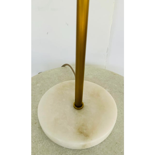 Stylish Arteriors Alabaster and Brass Finished Newport Table Lamp, white stone base and white fabric shade, showroom floor...