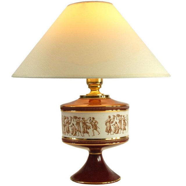 Decorative table lamp made of decorated and gilded Fiorentine ceramic. Adorned with a decal. Made in Italy in the 1950s,...