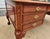 Traditional Chippendale-style executive desk, with richly carved cabriole legs and ball-and-claw feet giving it a formal...