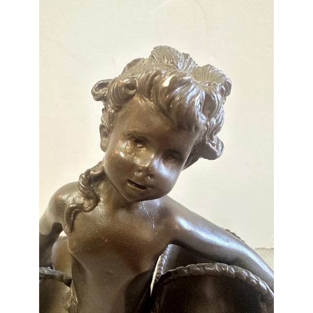 French style small rococo bronze sculpture of a young boy holding baskets. On marble stand. Signed as shown in close ups.