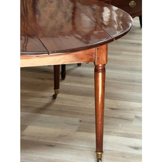 French Directoire Mahogany Extension Dining Table, c. 1800. 125 in., fully extended. Of lovely color and patina. With both...