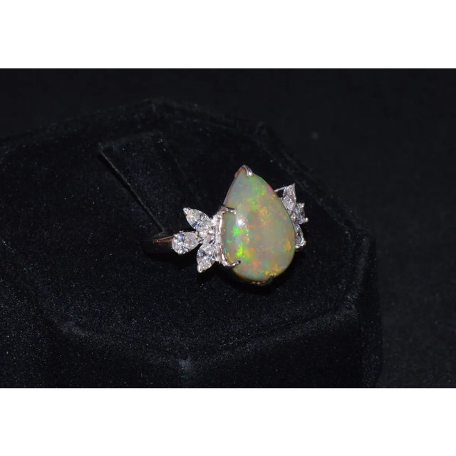Top quality natural opal and diamond cocktail ring. This ring features a huge 3.92CTS natural opal in center. The cabochon...