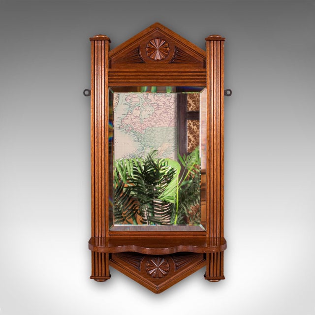 This is an antique hallway mirror. An English, walnut and bevelled glass valet or reception hall mirror, dating to the...