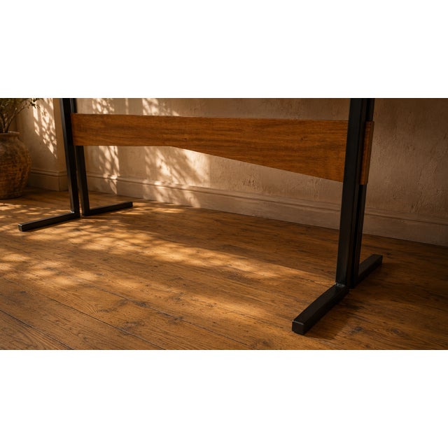 A low vintage coffee table with a long rectangular form and a clean, functional silhouette. The contrast between the...