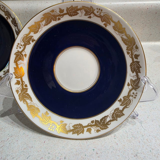 Features a distinctive gold grape vine pattern against a cobalt blue band. Below the main stamp on the middle piece, you...