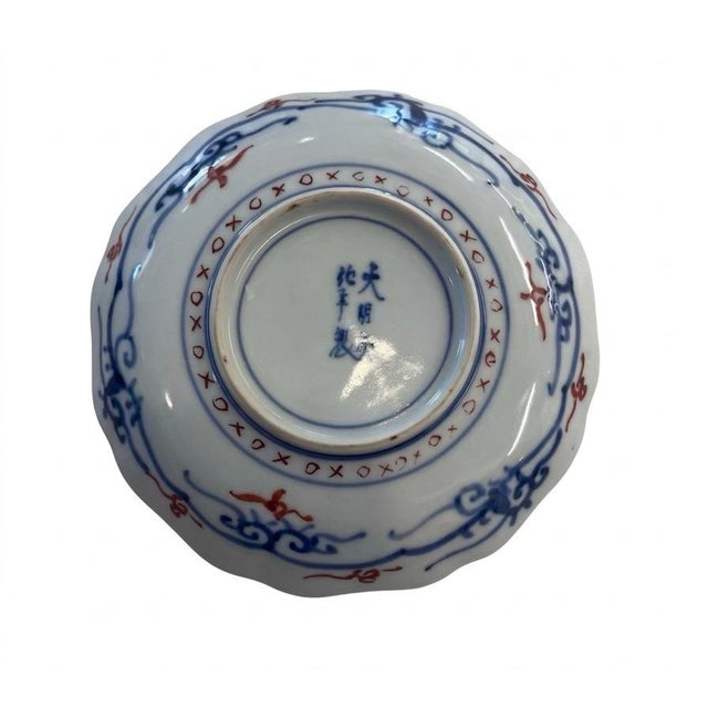 Vintage Japanese Imari porcelain plate The surface is divided into alternating panels featuring stylized floral blooms and...