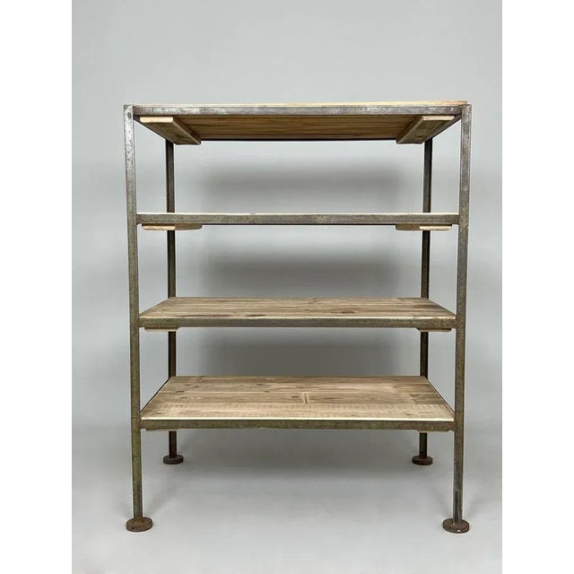 Vintage industrial shelf rack made of metal and wood. The original metal part was rescued from a factory in former...