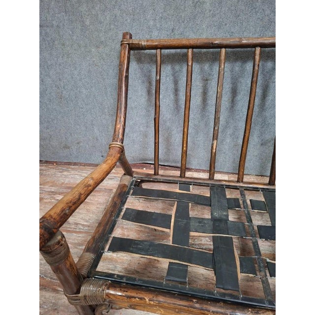A small bamboo sofa or bench with an exotic feel, dating from the early 20th century. this piece is distinguished by its...
