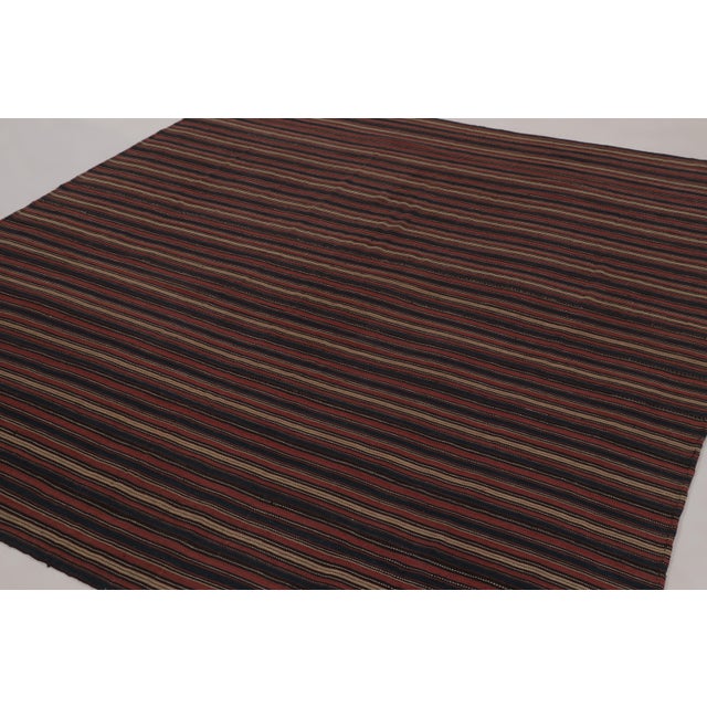 Made with handwoven wool circa 1950-1960, this 9x8 vintage Kilim is a particularly bright and sought-after work of an...