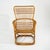 A rattan and woven cane armchair from the 1960s, characterised by its embracing structure and refined balance between...