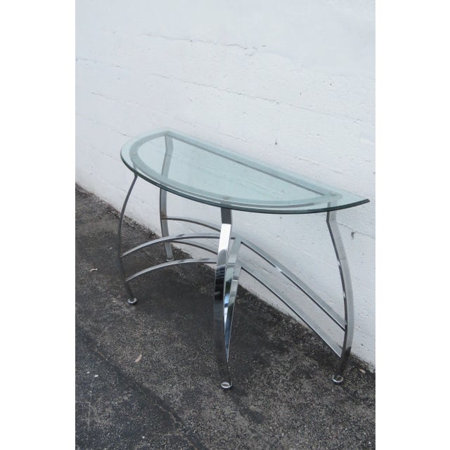 This classic Console Table is made out of metal, and it has a removable glass top. This Console Table has Hollywood...