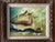 Oil painting depicting a tan, pink and golden conch shell resting on a surface against a softly blended blue green and...