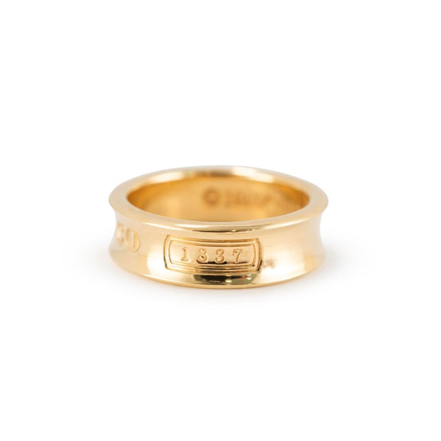 Brand: Tiffany & Co. Gender: Ladies Metal Type: 18K Yellow Gold Ring Size: 6.5 Width: 6.00 mm Weight: 7.56 grams TIFFANY &...