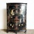 ional Chinese artistry. The cabinet's elegant demi lune shape is complemented by a rich black lacquered finish, providing...