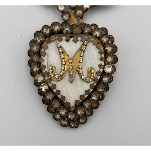 Exquisite 19th-century gilded metal Sacred Heart reliquary, featuring cut paste stones, mother-of-pearl inlay, and an...