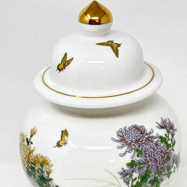 A substantial 12-inch Japanese ginger jar, decorated with butterflies, chrysanthemums and metallic gold accents. Good...