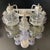A strikingly decorative lighting composition composed of modular elements in mold-blown glass with wavy, sculpted shapes,...