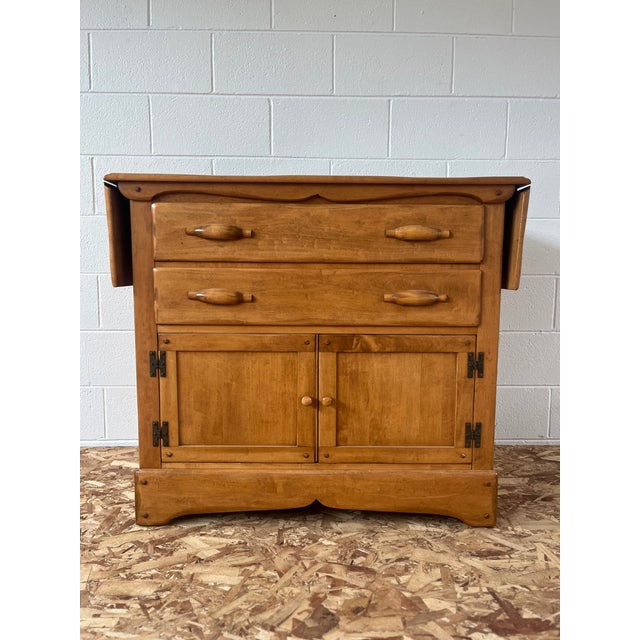 The sweetest vintage maple drop-leaf sideboard/credenza. Solid hardwood with two drawers, a bottom cupboard and two leaves...