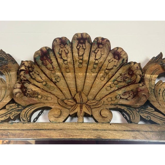 A striking and highly sculptural 20th century Italian carved wood mirror, richly ornamented with scrolling acanthus...