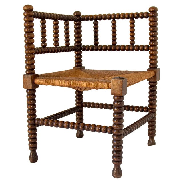 An evocative late-19th-century French Provincial corner chair, or coin du feu, handcrafted in France circa 1895....
