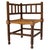 An evocative late-19th-century French Provincial corner chair, or coin du feu, handcrafted in France circa 1895....