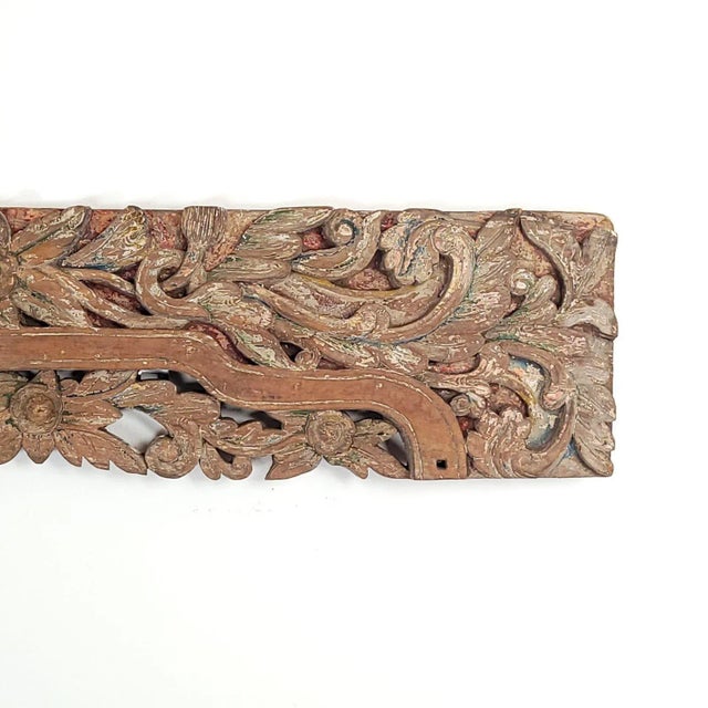 A Southeast Asian hardwood heavily carved lintel, 19th century or earlier.