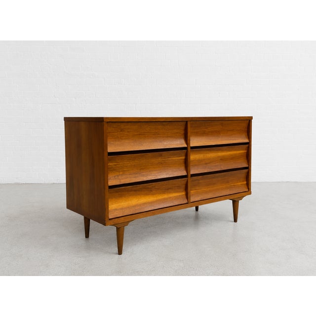 Mid Century Modern Walnut Lowboy Dresser, c. 1960s. This beautifully refinished six-drawer dresser features warm walnut...