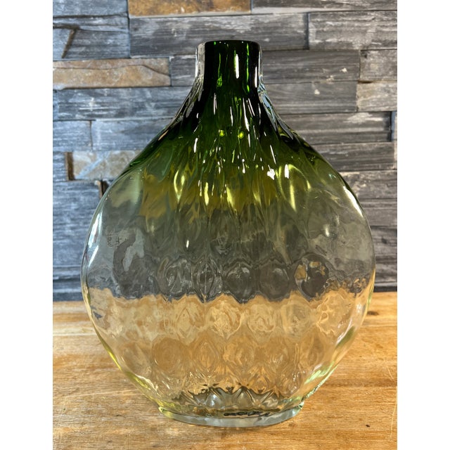This 12-inch tall hand-blown tear-shaped art glass vase is a testament to the skill and creativity of the glass artisan....