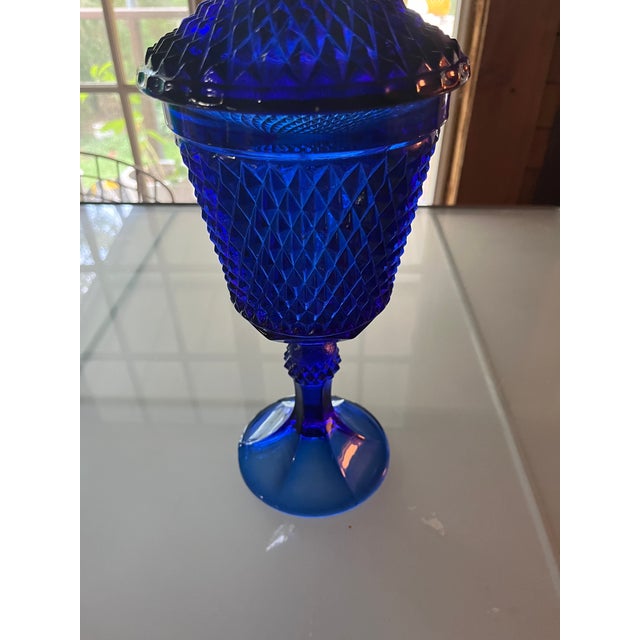 Very unique vintage urn style vase with lid. Bright cult bolt blue hobnail design from 1960’s. About 15.5” tall.
