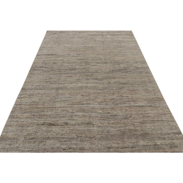 Hand-knotted in wool, silk , this 6x9 contemporary simple rug in gray and beige as an addition to the Rug & Kilim’s...