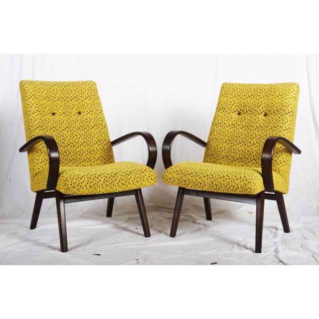 This pair of armchairs from the mid-1960s are made from beechwood and bentwood with upholstery, remaining in an original...