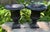 A vintage traditional pair of cast iron planters, each standing 14" tall, 11.5 round and weighing right around 17 pounds.