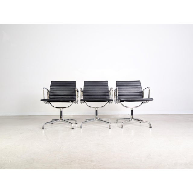 We are offering one of three beautiful Vitra EA 108 chairs with black leather upholstery for sale. Designed by Charles and...