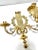 A decorative pair of vintage brass wall candle sconces in the Louis XVI style, featuring architectural laurel and acanthus...