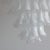A very large chandelier with a white painted steel frame and well over 130 hand-blown 'saddle form' glass pieces. Clear...