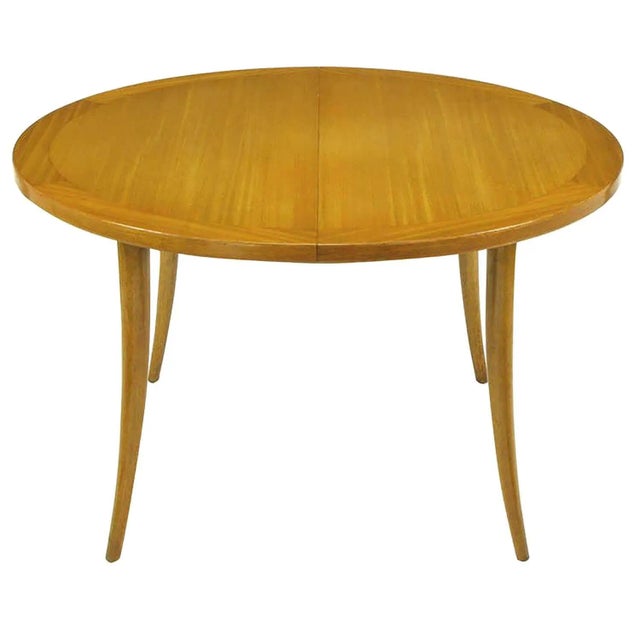 Bleached and toned mahogany sabre leg dining table by Harvey Probber. Parquetry bordered and exceptional wood grained top...