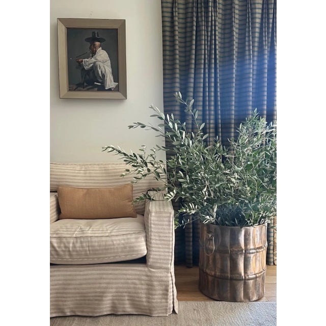 Large brass Jardiniere planter having a hand-forged cylinder base with vertical fluting pattern, generous sized oval ring...