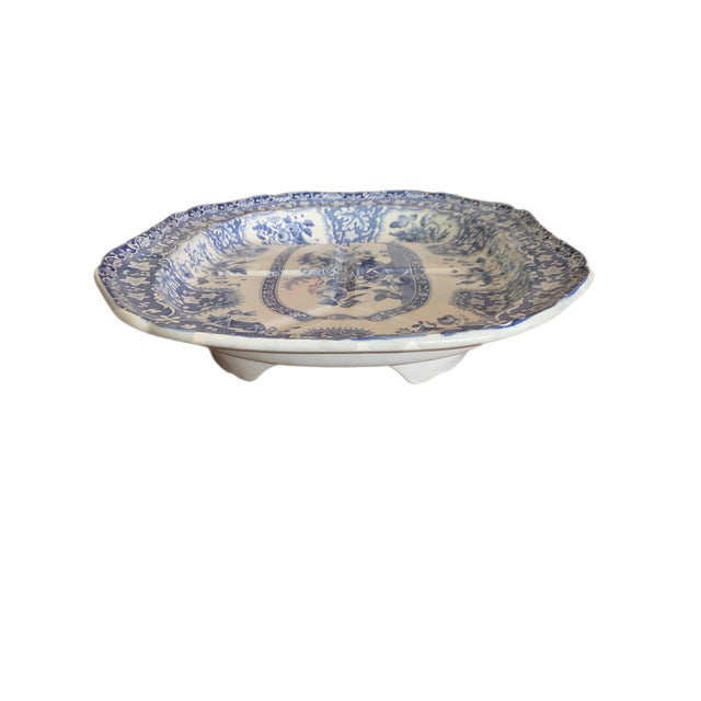 This is a large Spode meat platter. The pattern is decorated with flower arrangements and leaves. In the center is a large...