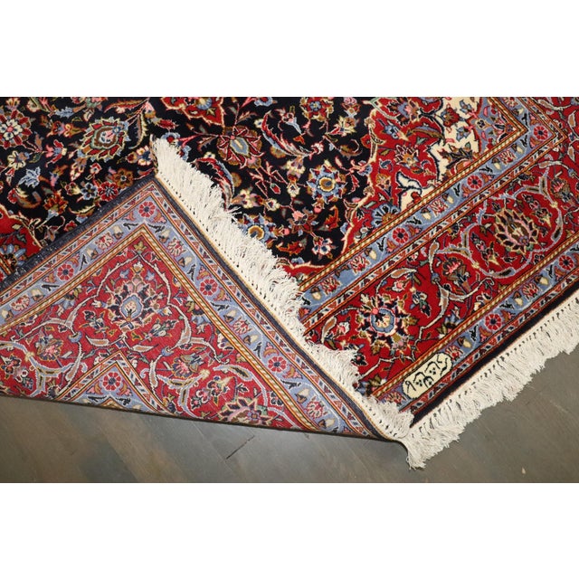 A mid 20th Century Signed Persian Kashan Rug. The Persian script in that ivory section reads: کاشان (Kashan) 4'5'' x 7'4''