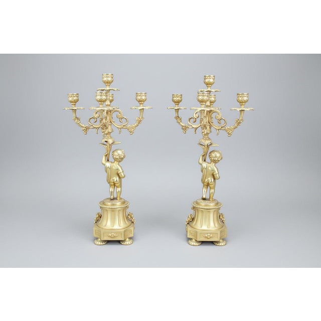 Fonderia Bronzi Artisici Italia (F.B.A.I), Exquisite Italian Rococo style gilt bronze candelabra pair featuring putto or...
