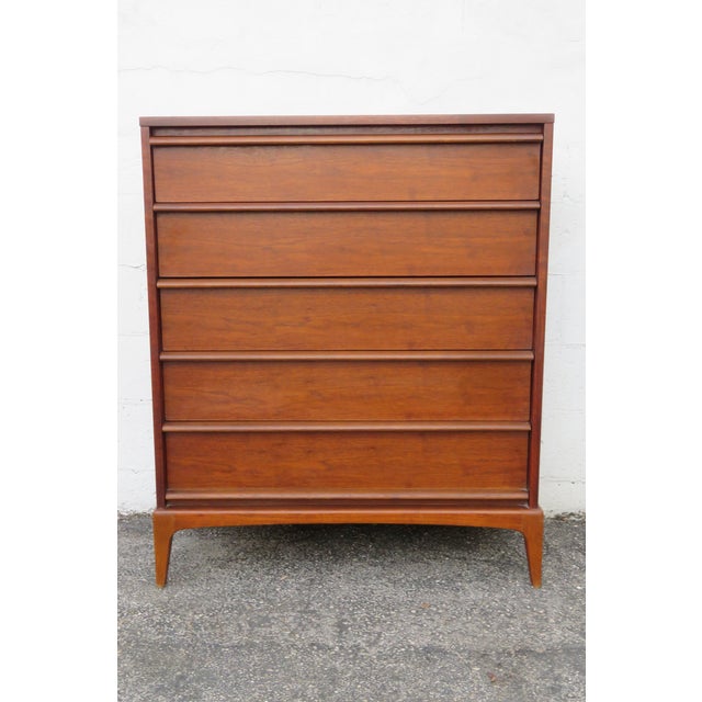 This magnificent Chest of Drawers is made of wood, walnut, and veneer. It was made by Lane Furniture, a well known company...