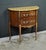 This charming little half-moon commode embodies the delicate elegance of the Louis XV-Louis XVI Transition style, a blend...