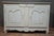 Small rustic Louis XV period sideboard in natural wood with an antique off-white patina. The front opens with two molded...