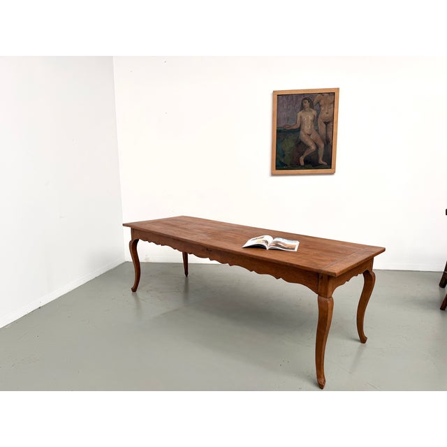 Large 1900s farmhouse table in solid cherry wood, featuring elegant curved legs and a scalloped apron. Completely restored...